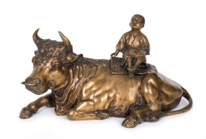 A Chinese cast bronze statue of a boy sitting on a recumbent bull, 19th /20th century, ​​​​​​​26cm high, 61cm long