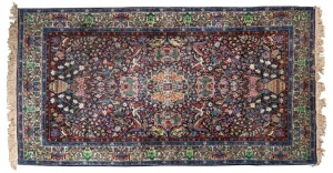A Persian hand-knotted wool rug with blue and green floral design, 20th century, ​​​​​​​260 x 151cm