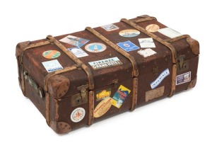 A travel trunk, handsomely adorned with travel labels, early 20th century, 33cm high, 94cm wide, 51cm deep