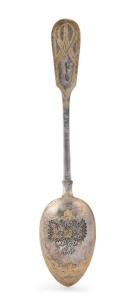An antique Russian silver serving spoon, spectacularly engraved with Romanov coat of arms adorned with niello and gilt highlights, by Khlevnikov of St. Petersburg, royal warrant mark with Cyrillic marker's stamp and Russian silver 84 standard mark, 20.5cm