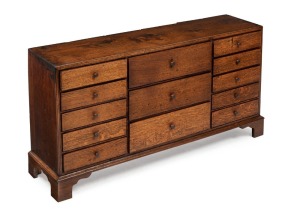 An unusual low collector's chest of 13 drawers, oak and elm on bracket feet, 19th century, 56cm high, 113cm wide, 28cm deep