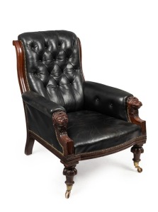 An antique English mahogany armchair with carved lion mask hand rests and button back black leather upholstery, 19th century, 71cm across the arms