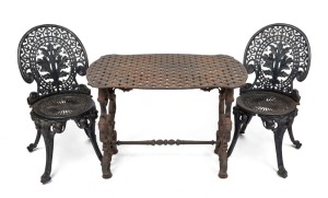 A three piece cast iron garden setting with black painted finish, 19th and 20th century, ​​​​​​​the table 64cm high, 89cm wide, 56cm deep