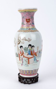 A Chinese famille rose porcelain vase with scene of women in a garden setting, with carved wooden stand, 20th century, seal mark to base, ​34cm high