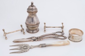 Sterling silver pepper grinder, pair of sterling silver knife rests (a/f), Australian silver napkin ring, sterling silver bread fork and a pair of silver plated grape scissors, 19th and 20th century, (6 items), the pepper grinder 10cm high