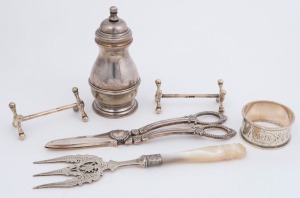 Sterling silver pepper grinder, pair of sterling silver knife rests (a/f), Australian silver napkin ring, sterling silver bread fork and a pair of silver plated grape scissors, 19th and 20th century, (6 items), ​the pepper grinder 10cm high