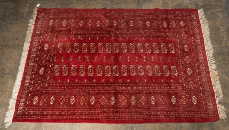 A Persian hand-knotted rug with red background, 195 x 130cm