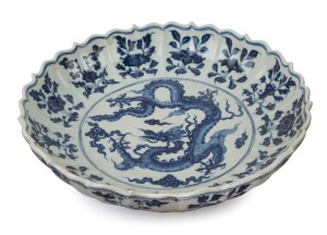 A Chinese lotus shaped porcelain serving bowl with dragon decoration, 19th/20th century, six character mark to base, ​32cm wide