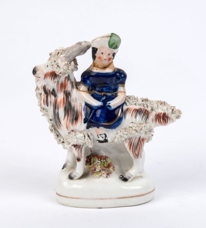 STAFFORDSHIRE English pottery statue of a girl sitting on a goat, 19th century, ​13cm high