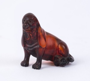 A Japanese carved amber netsuke in the form of a sitting dog, Meiji period, 19th/20th century, ​4cm high, 5cm long