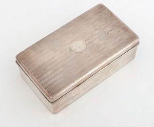 A silver cigarette box with cedar lining, circa 1920, ​5cm high, 16cm wide, 9cm deep.