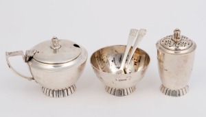 An English sterling silver condiment set comprising a salt cellar, mustard pot, pepper pot and two matching spoons. Made by Wakely & Wheeler of London, circa 1909, the pepper pot 7cm high, 208 grams total
