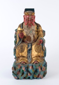 A Chinese statue of a seated man, carved wood with polychrome finish, 20th century, ​40cm high