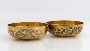 A pair of Chinese brass finger bowls with dragon motifs, late Qing Dynasty, circa 1900, 4cm high, 11cm diameter