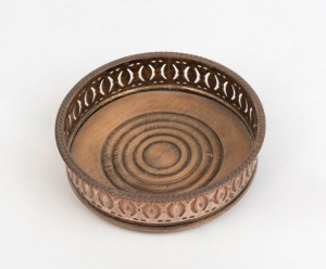 An antique silver plated wine bottle coaster, 19th century, mellow rubbed finish with copper highlights, 4cm high, 13.5cm diameter