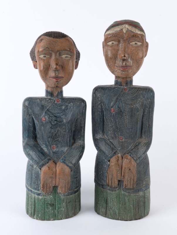 A pair of Malay statues, carved wood with polychrome finish, 20th century, ​38cm and 40cm high