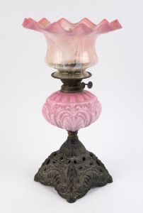 An antique kerosene lamp with pink glass font and shade, double burner and cast iron base, late 19th century, ​​​​​​​55cm high overall