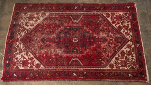 A Persian hand-knotted wool rug with crimson and cream ground, (worn), 190 x 130cm