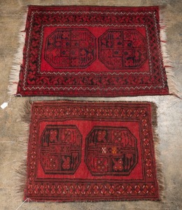 Two Afghan red and black hand-knotted rugs, the larger 104 x 72cm