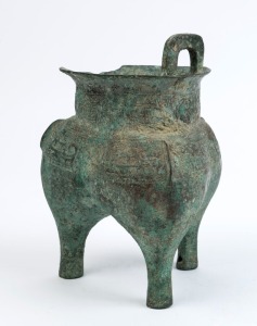 A Chinese archaic style bronze censer resting on three feet, (missing one handle), ​​​​​​​22.3cm high