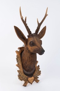 A Black Forest carved deers head with shell eyes and genuine deer antlers, 20th century, ​​​​​​​62cm high, 31cm wide