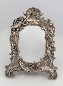 An ornate sterling silver framed table mirror, 20th century, 24cm high