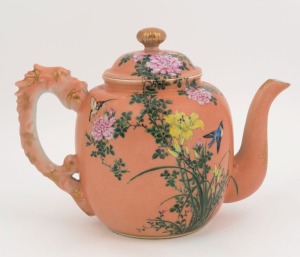 A Chinese porcelain teapot with enamel decoration on salmon ground with dragon handle, Republic period, underglaze four character mark to base, 17cm high, 24cm wide