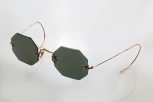 A pair of antique sunglasses in case, remodelled with new lenses