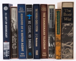 A Folio Society collection of hardcover books on WARFARE including No Cloak, No Dagger by Cowburn; Memoirs of a British Agent by Lockhart; All Quiet on the Western Front by Remarque; The Boer War by Pakenham; The Zimmermann Telegram by Tuchman, and severa