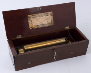 An early Ducommun music box with key wind movement, 27cm cylinder playing 6 airs in mahogany case with marquetry dance scene on the top, 19th century, with original key and running, 13cm high, 48cm wide, 17cm deep