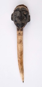 A tribal dagger with figural decoration, carved bone, clay, shell and hair with painted finish, Papua New Guinea, 39cm high