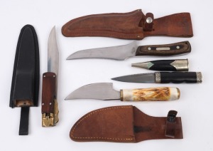 Four assorted hunting knives in scabbards, 20th century, ​​​​​​​the largest 26cm long