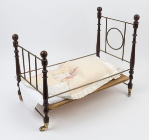 A dolls miniature bed with bedding, 20th century, ​49cm high, 30cm wide, 54cm long