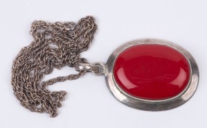 A silver and carnelian pendant on silver chain, stamped "925", the pendant 5cm high, the chain 60cm long