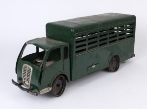 A scratch built cattle truck, painted metal and aluminum with rubber rimmed tyres; incomplete, circa 1935, with remnants of electric wiring and drive train mechanism, 65cm long, 16.5cm wide