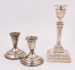 An Adams style sterling silver candlestick by Walker and Hall together with a pair of sterling silver candle holders, early 20th century, (3 items), the largest 21cm high