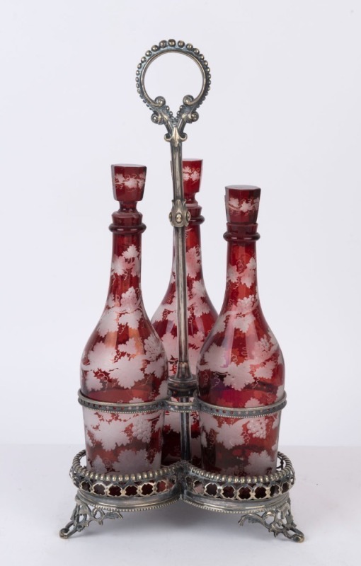 An antique silver plated decanter stand with a fine set of three ruby overlay glass decanters, 19th century, ​​​​​​​46cm high overall