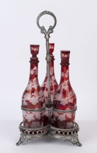 An antique silver plated decanter stand with a fine set of three ruby overlay glass decanters, 19th century, 46cm high overall