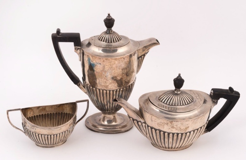 An English three piece sterling silver tea service by John Round of Sheffield, circa 1906, ​​​​​​​the water pot 19cm high, 672 grams total
