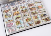 1900s-1930s British array of Wills or John Player cigarette cards with many largely complete or complete sets, with themes including aeroplanes, crests/arms, military uniforms & headdress, birds, wildlife, flowers, etc.; condition fair to VG. (1000+ cards - 3