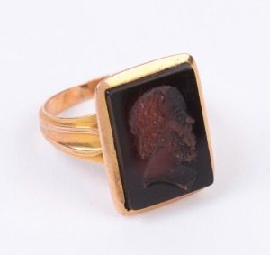 An antique yellow gold signet ring with intaglio cut Italian black glass male profile portrait, 19th century,