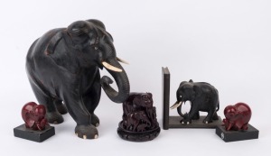 Five assorted elephant ornaments, carved wood and resin with bone tusks, 19th and 20th century, the largest 34cm high