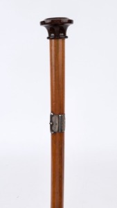 An antique walking stick with jasper handle inset with a compass, silver belt buckle collar, Malacca cane shaft and brass ferrule, ​​​​​​​89cm high