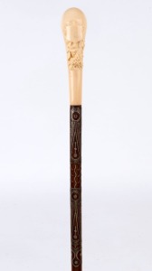 An antique walking stick with carved ivory handle silver inlaid timber shaft and brass ferrule, 19th century, ​​​​​​​96cm high