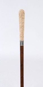 An antique walking stick with carved ivory handle, silver collar, cane shaft and brass ferrule, ​​​​​​​90cm high