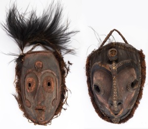 Two tribal masks, carved wood, shell, feather and earth pigments, Papua New Guinea, ​​​​​​​the larger 70cm high