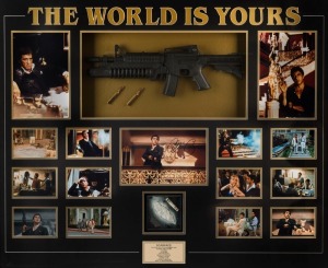 THE WORLD IS YOURS: A large and impressive "Scarface" movie presentation featuring a signed photograph of Al Pacino, 14 other photographic stills from the 1983 movie, a replica sub-machine gun with bullets, a pile of "white powder" and a rolled-up replica