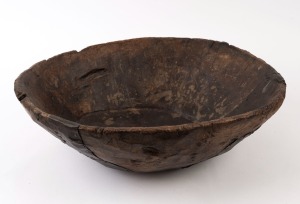 An antique Korean bowl, carved wood with iron strapping, 19th century, ​18cm high, 54cm wide