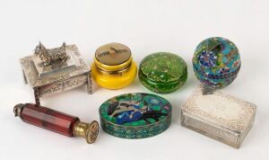 An antique English sterling silver lidded glass box, and Indian silver and enamel box, an apple shaped cloisonne box, two circular glass boxes, a silver plated jewellery box with dog finial and a ruby glass scent bottle, (A/F), 19th and 20th century, the scent bottle 12.5cm long