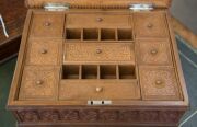 An Anglo-Indian workbox, superbly carved on all sides, with claw feet and compartmented lift out tray fitted with lids, early to mid 19th century, 18cm high, 32.5cm wide, 25.5cm deep - 9